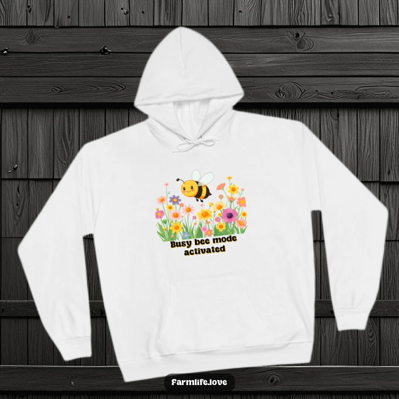 Funny hoodie: A joyful bee happily buzzes through a field of vibrant flowers, radiating cheerful, busy energy.